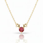 Full view of a gold reindeer antler necklace with a vibrant red cubic zirconia stone, presented on a pure white background with a subtle reflection.